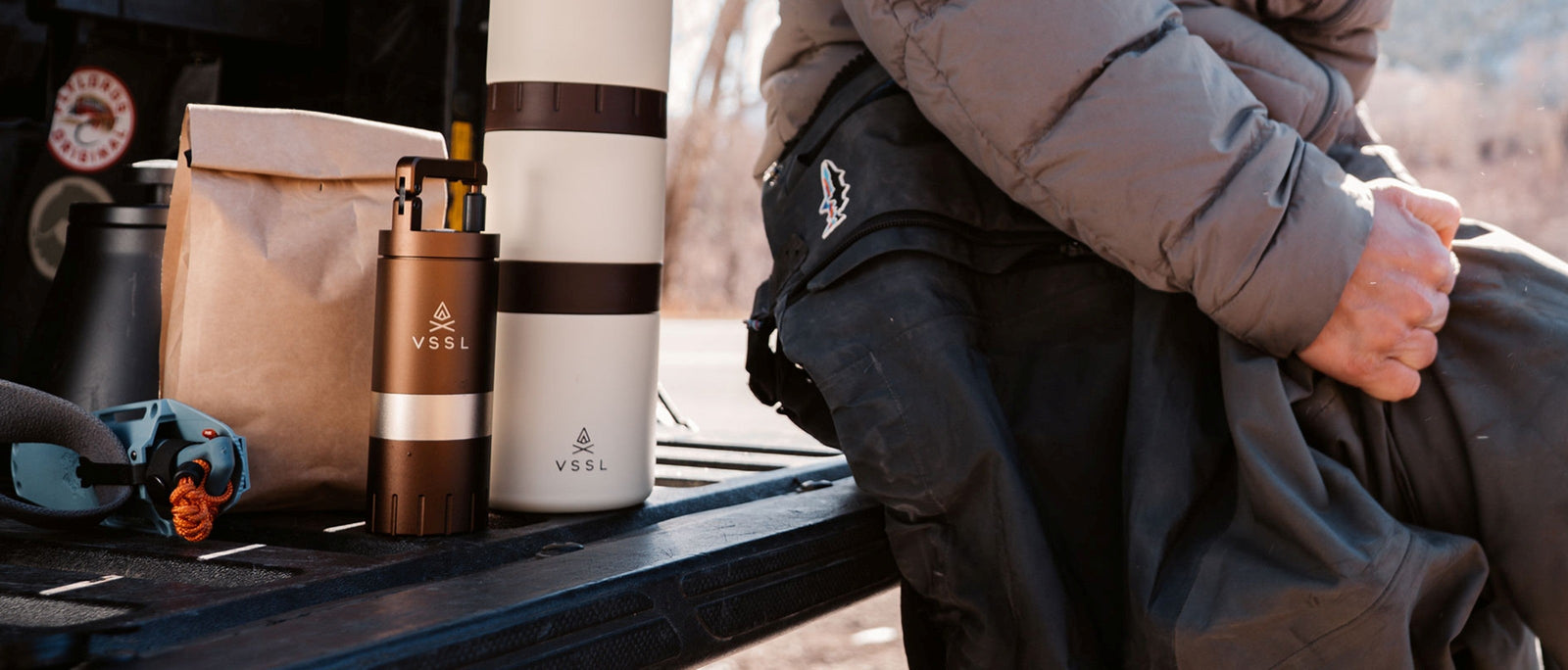 VSSL Java portable coffee grinder and Nest pour-over kit on the back of a vehicle tailgate during a backcountry fly fishing trip.